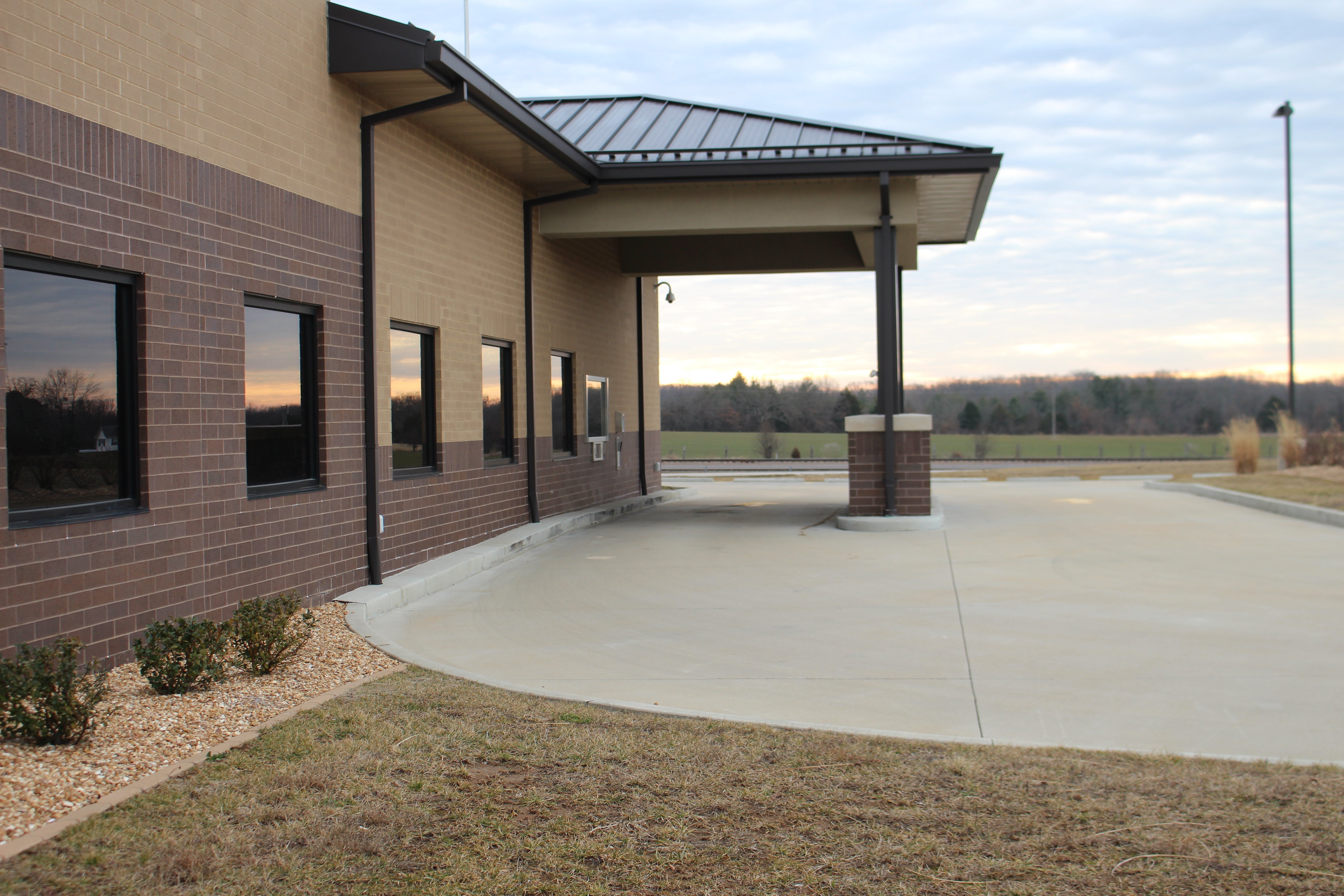 Building with driveway and windows on the side of the building.